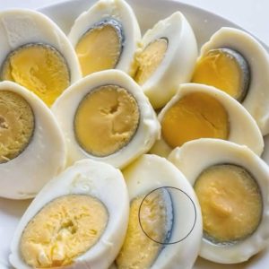 Why does a green ring appear around hard-boiled eggs?